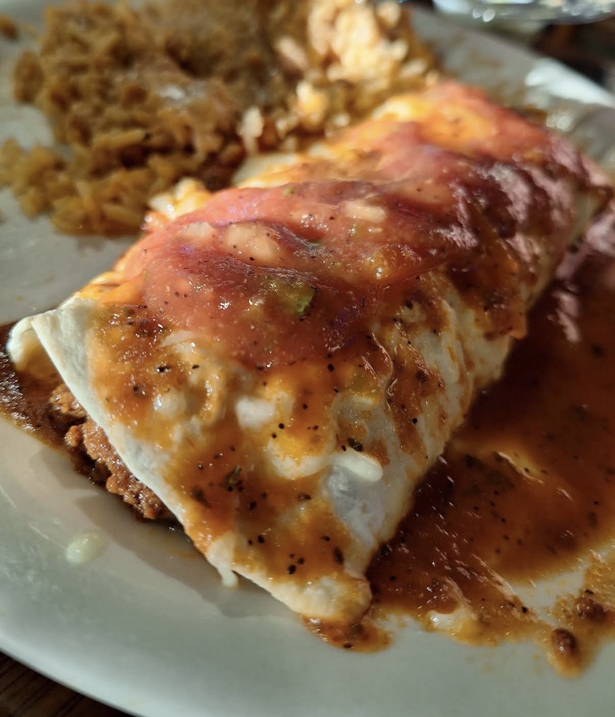 Smothered burrito with red sauce and Mexican rice
